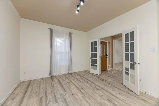 an empty room with wooden floor and closet