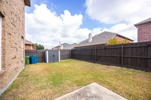 a view of backyard with wooden fence