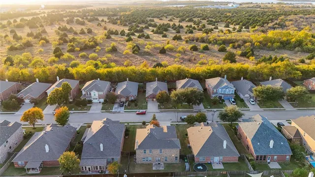 an aerial view of residential houses with outdoor space and swimming pool