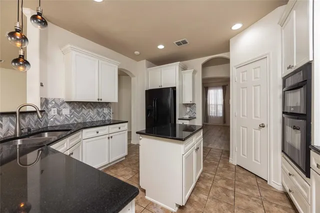 a kitchen with stainless steel appliances a sink stove and refrigerator