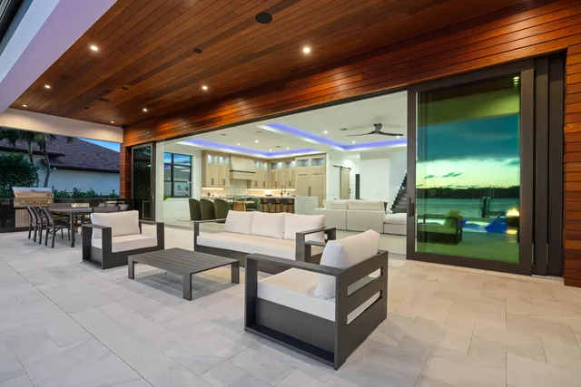 a view of a patio with table and chairs potted plants with wooden floor