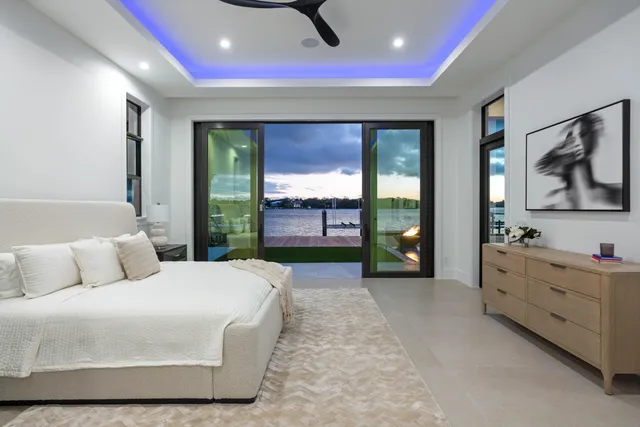 a bedroom with a bed and a large window