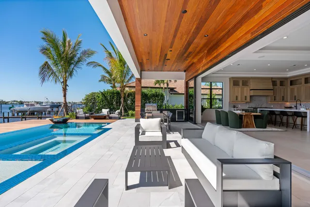 a view of a patio with swimming pool table and chairs