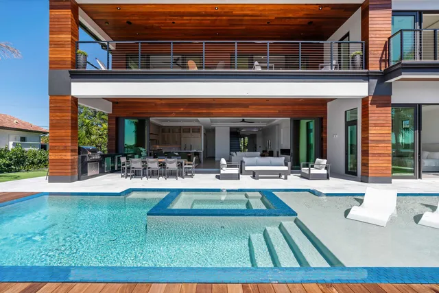 a view of a patio with couches table and chairs and potted plants