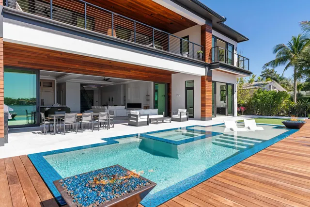 a view of a swimming pool with outdoor seating