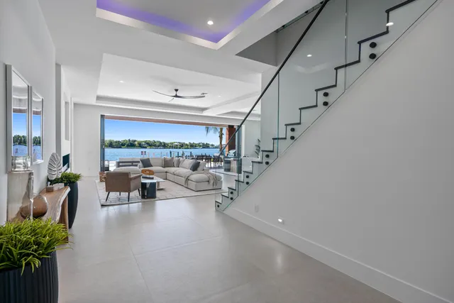 a living room with furniture and kitchen view