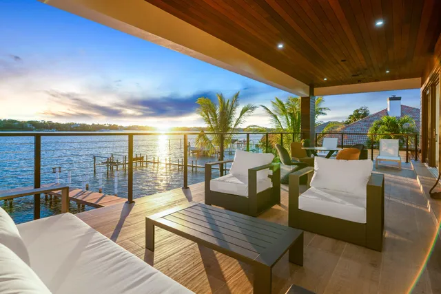 a living room with patio furniture and a fireplace