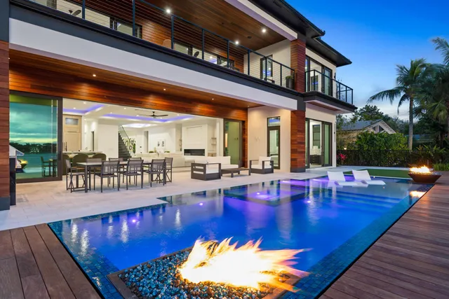 a view of a swimming pool with outdoor seating