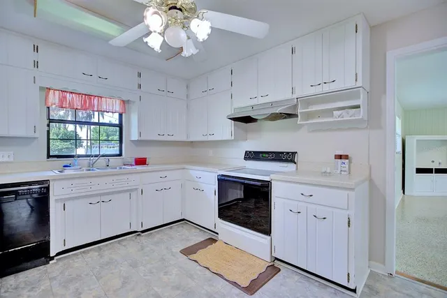 a kitchen with stainless steel appliances granite countertop cabinets and window