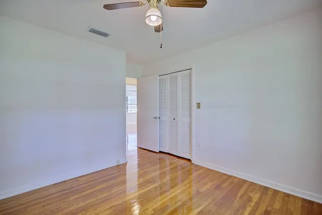 a view of an empty room with wooden floor