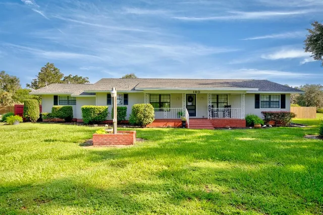 a view of a house with a backyard