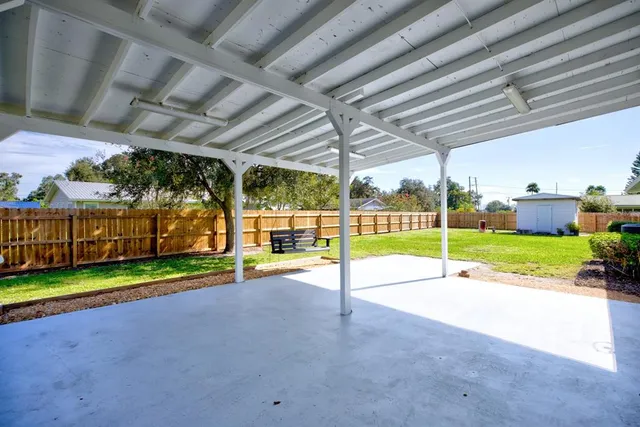 a view of a backyard with wooden fence