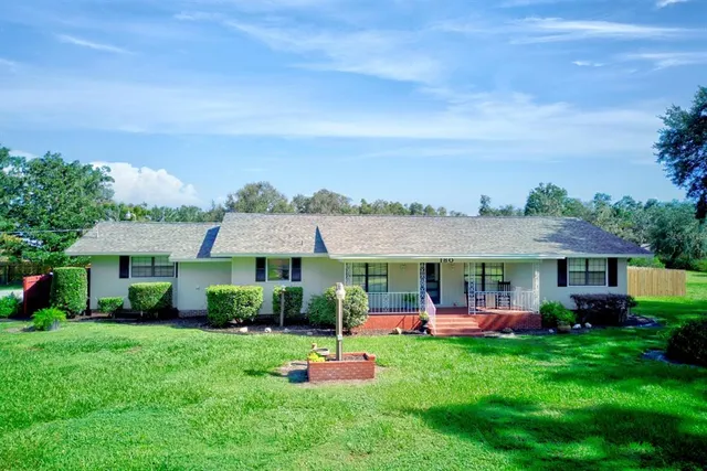 a front view of a house with a yard table and chairs