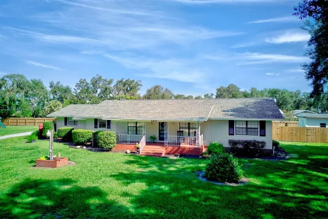 a front view of a house with a yard table and chairs