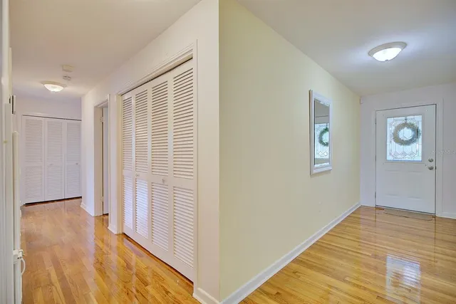 a view of a room with wooden floor and a bathroom