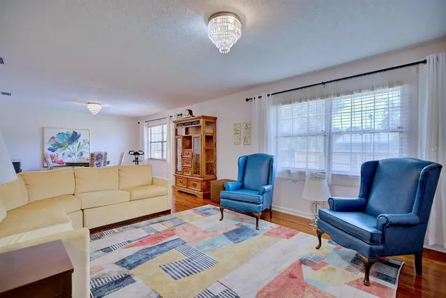 a living room with furniture a rug and a window