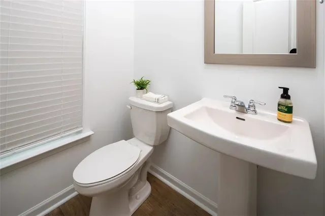 a white toilet sitting next to a bathroom sink