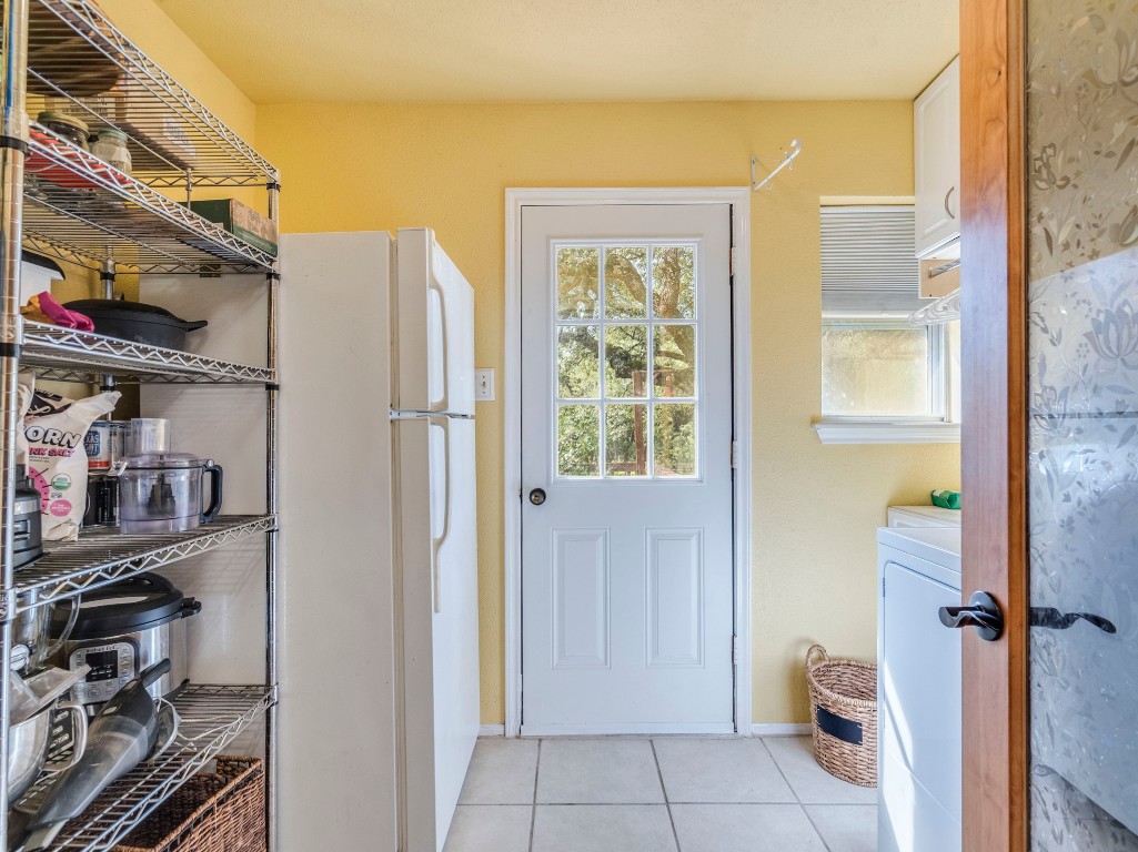 16019 Arbor Trail Buda, TX 78610 - Photo 23 of 40 Just through the kitchen, the utility room has more storage for pantry items or kitchen necessities as well as secondary fridge or freezer!