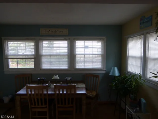 a view of a dining room with furniture and windows
