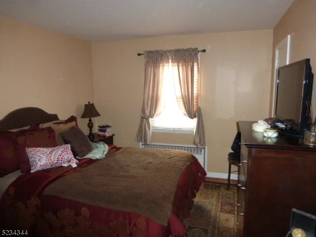 a bed sitting in a bedroom next to a window