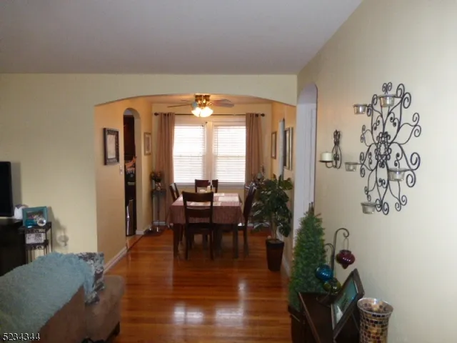a dining room with furniture and wooden floor
