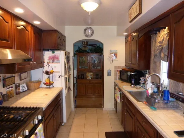 a kitchen with stainless steel appliances a sink stove and refrigerator