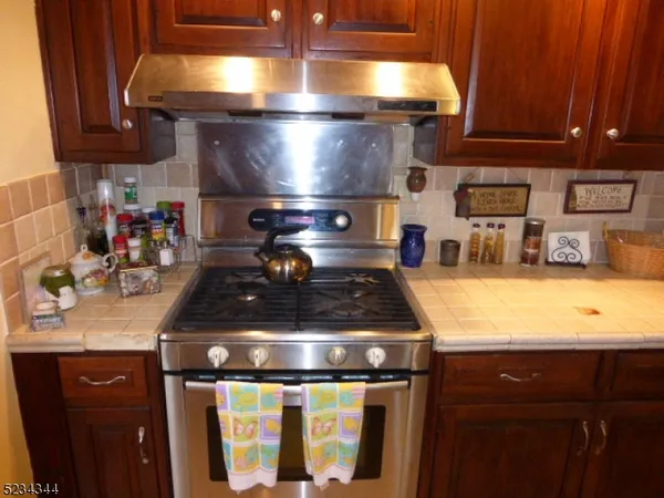 a kitchen with a stove and cabinets