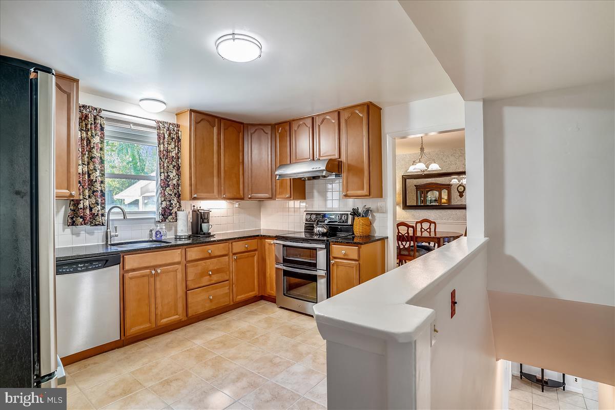 18901 Muncaster Road Derwood, MD 20855 - Photo 19 of 58 Kitchen has great light, stairs to lower level