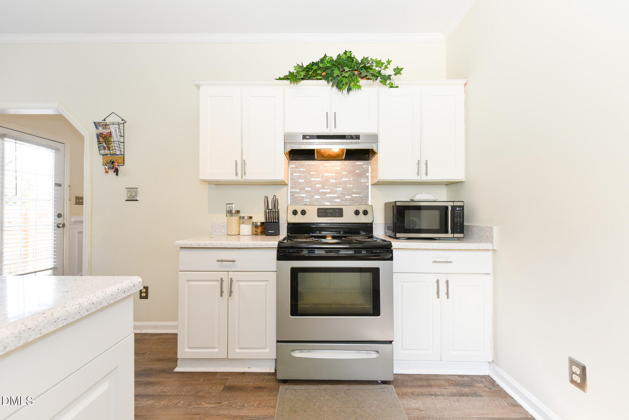 2036 Star Sapphire Drive Raleigh, NC 27610 - Photo 11 of 23 a kitchen with granite countertop white cabinets and white appliances