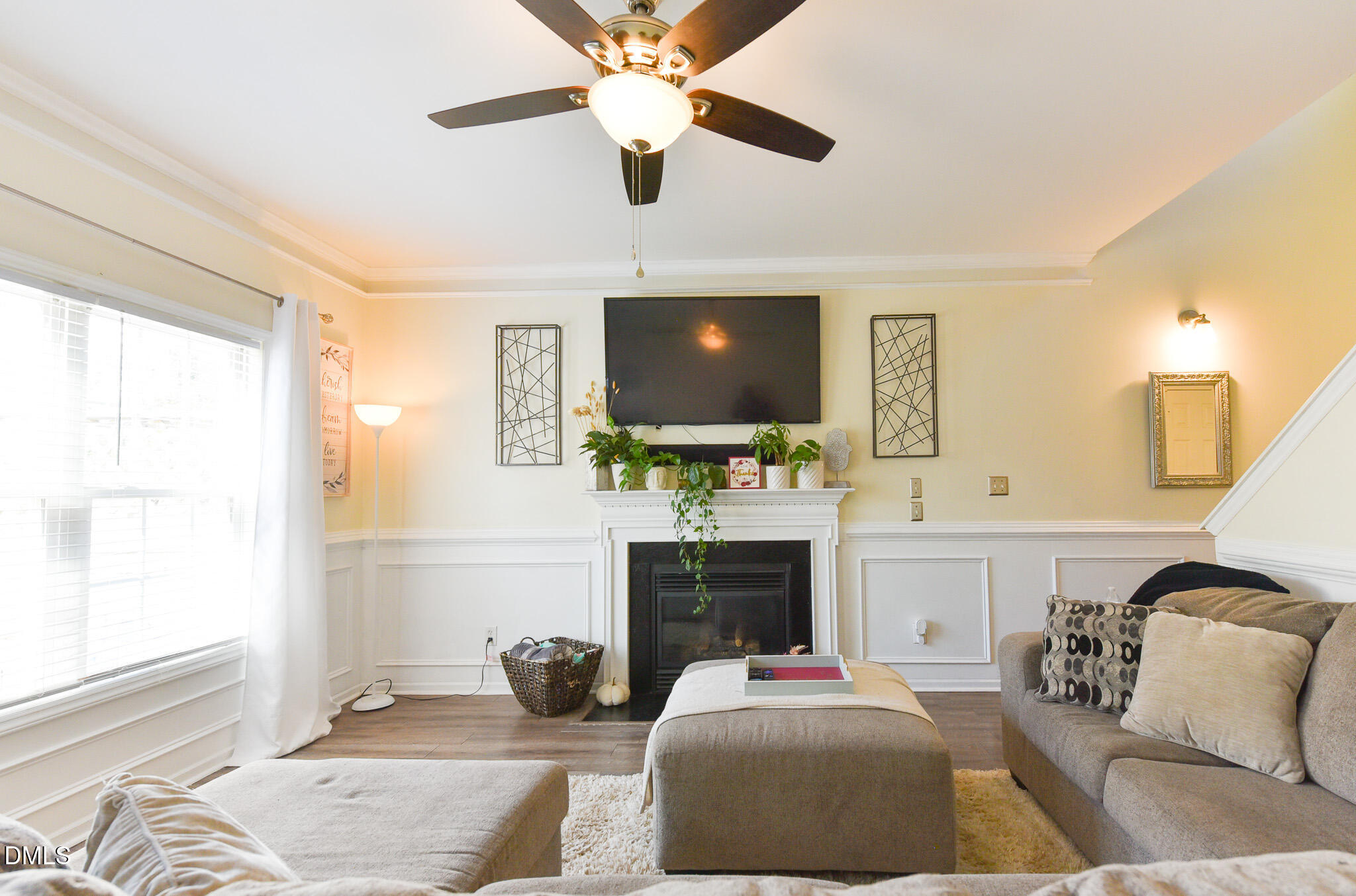 2036 Star Sapphire Drive Raleigh, NC 27610 - Photo 4 of 23 a living room with furniture a fireplace and a flat screen tv