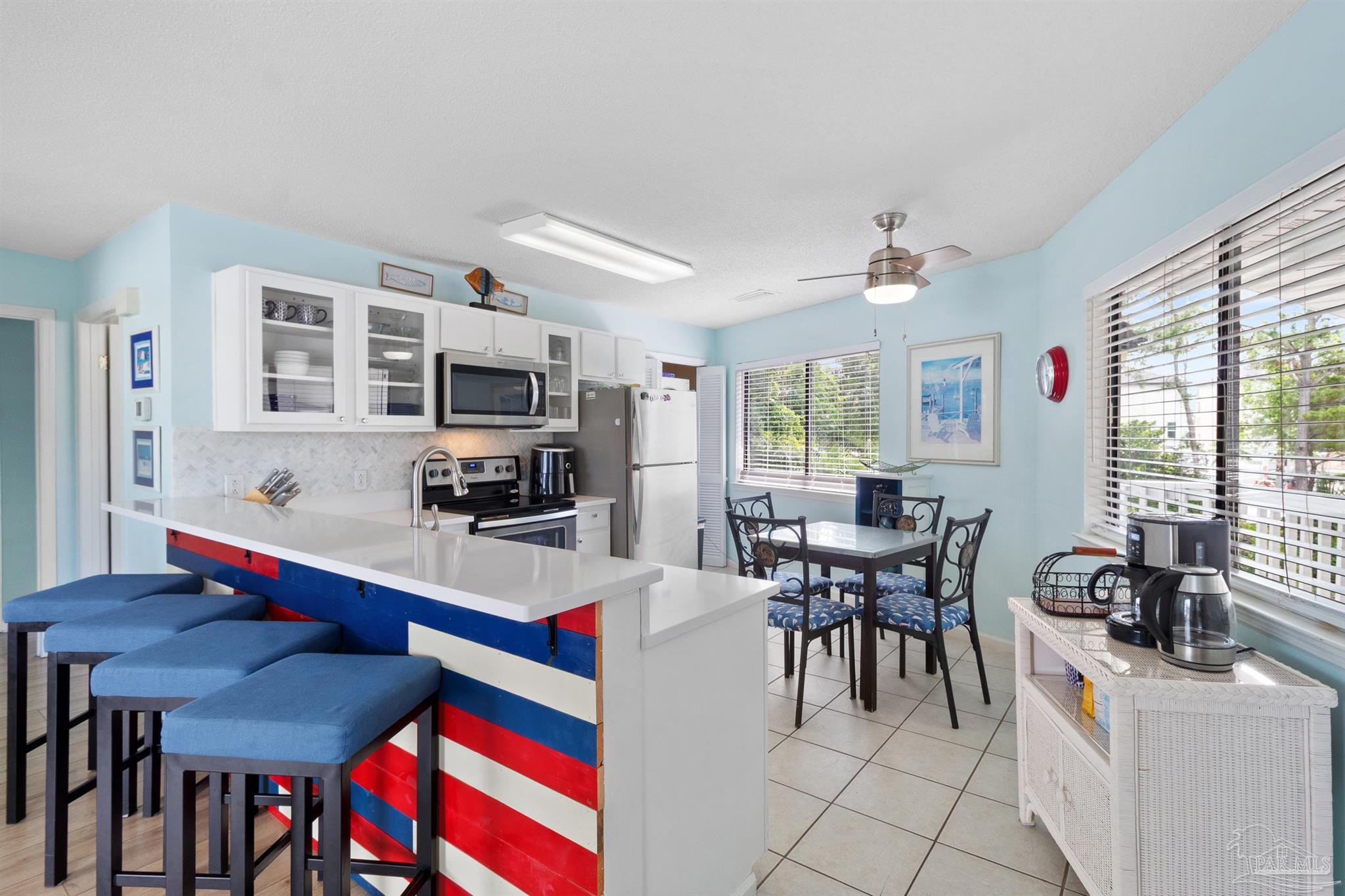 285 Payne Street, Unit 21B Miramar Beach, FL 32550 - Photo 11 of 42 a view of a dining room with furniture and a large window