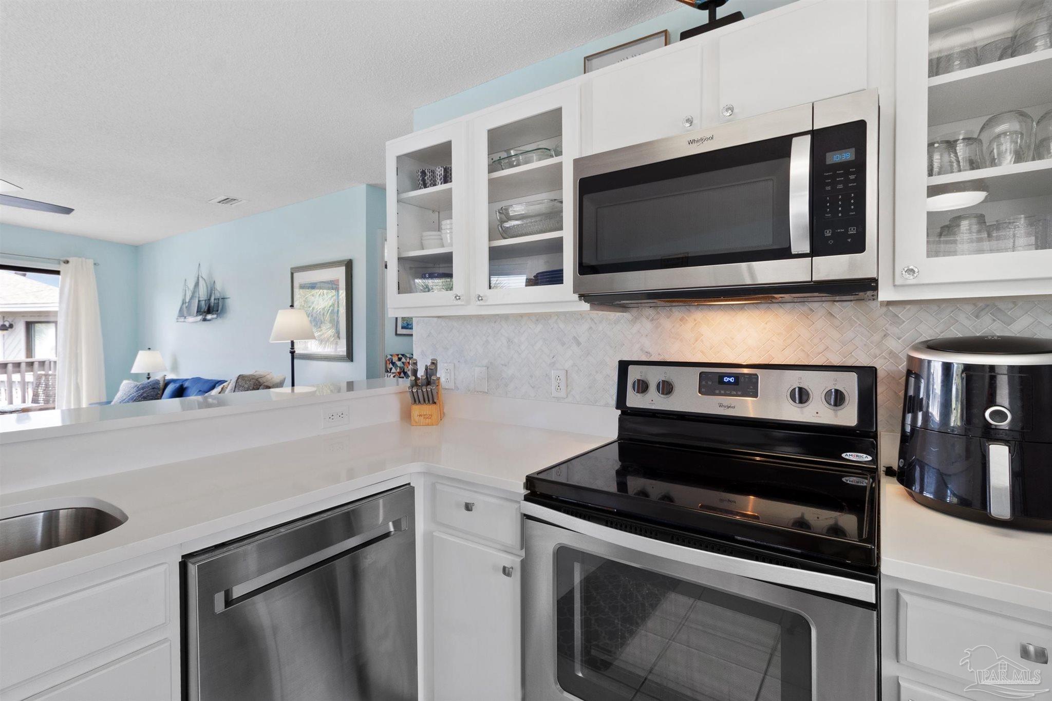 285 Payne Street, Unit 21B Miramar Beach, FL 32550 - Photo 18 of 42 a kitchen with a stove and a microwave