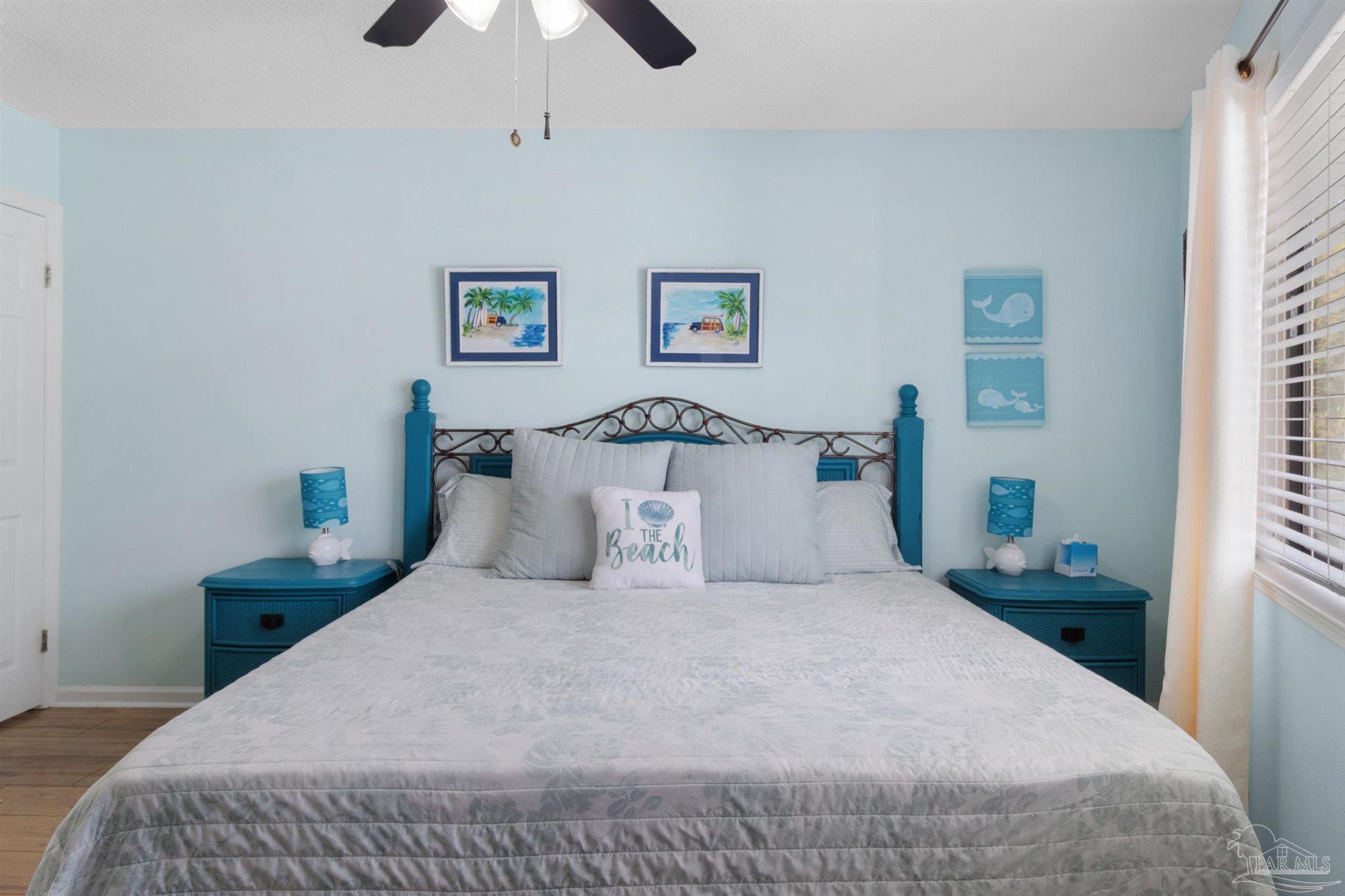 285 Payne Street, Unit 21B Miramar Beach, FL 32550 - Photo 22 of 42 a bedroom with a bed and a chandelier