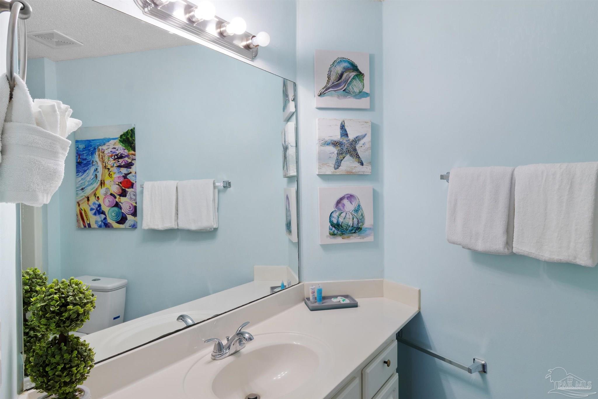 285 Payne Street, Unit 21B Miramar Beach, FL 32550 - Photo 23 of 42 a bathroom with a sink and a mirror