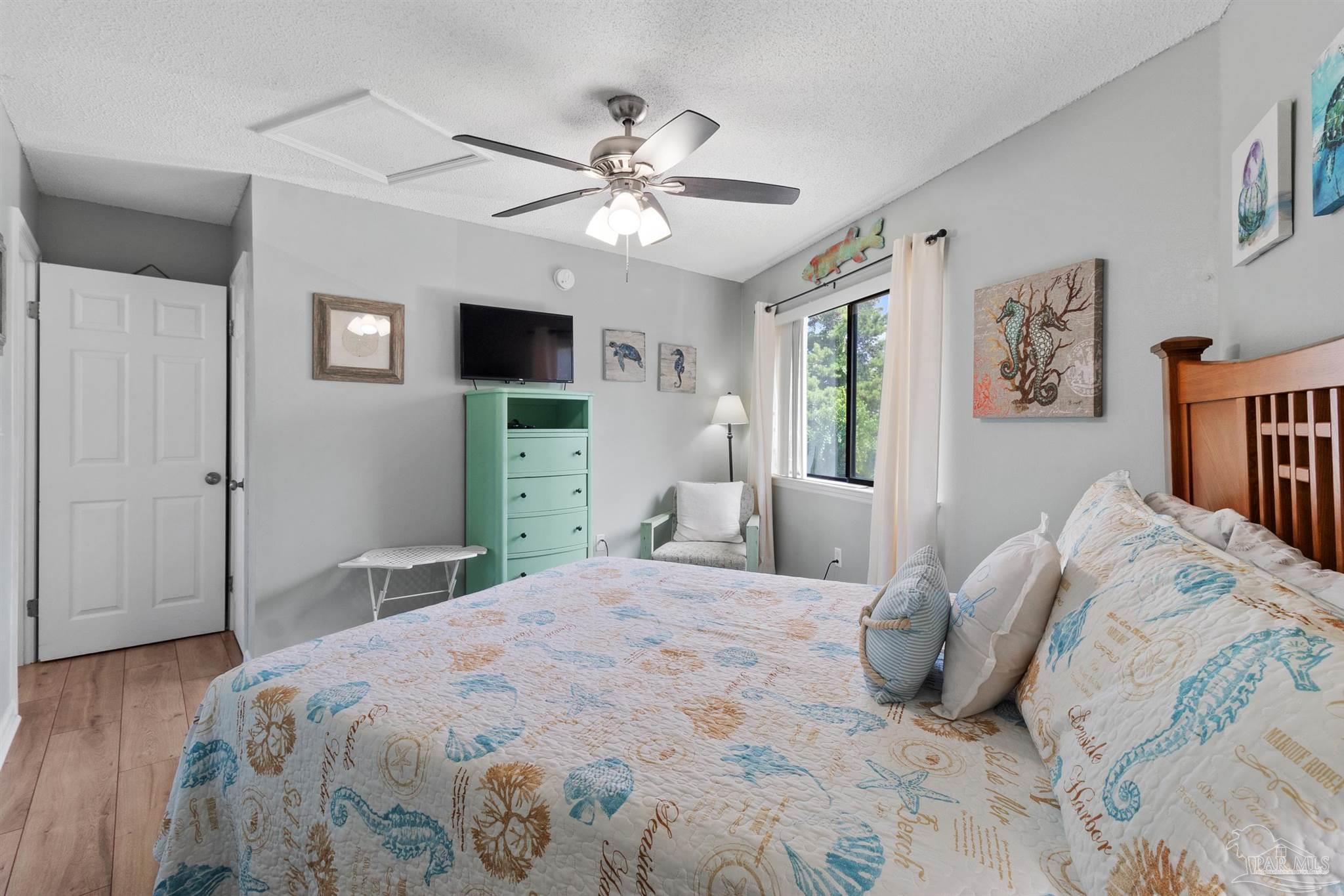 285 Payne Street, Unit 21B Miramar Beach, FL 32550 - Photo 26 of 42 a bedroom with a large bed and a flat tv screen