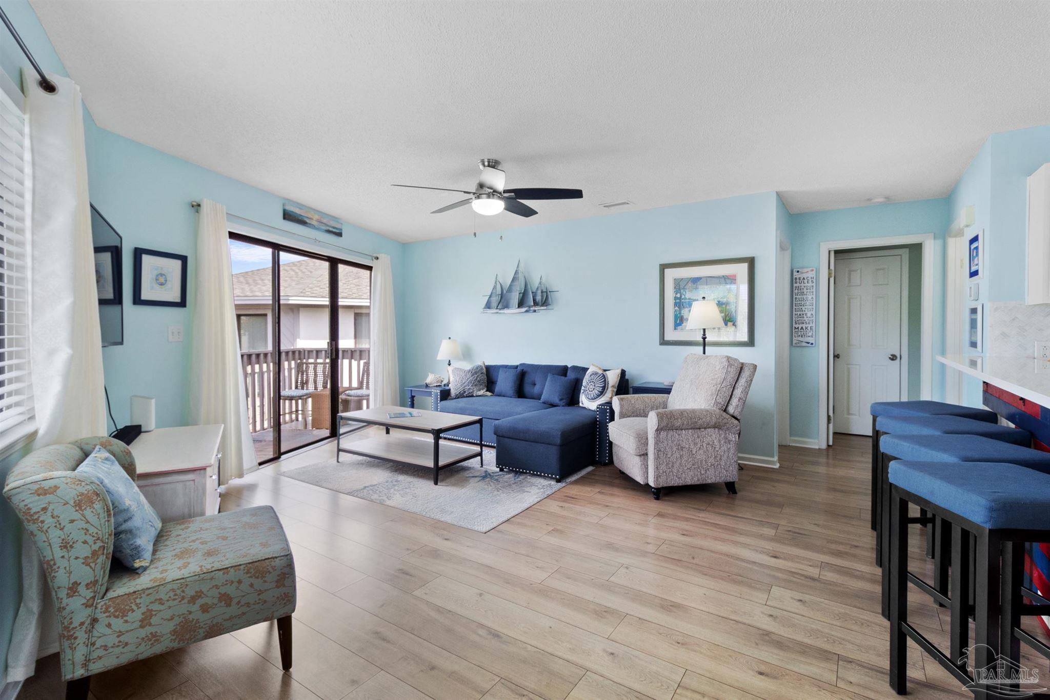 285 Payne Street, Unit 21B Miramar Beach, FL 32550 - Photo 3 of 42 a living room with furniture and a wooden floor