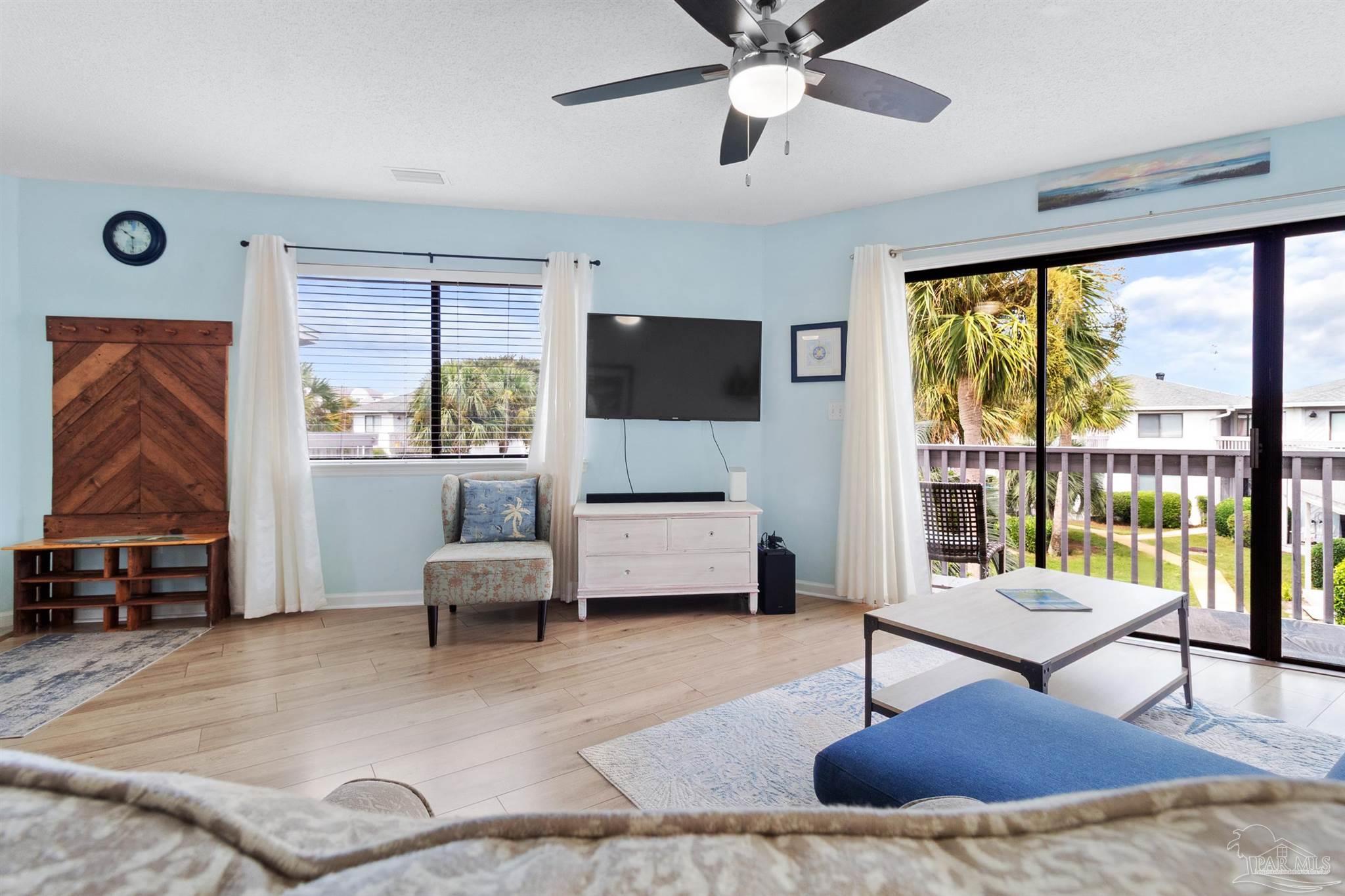 285 Payne Street, Unit 21B Miramar Beach, FL 32550 - Photo 9 of 42 a living room with furniture and a flat screen tv