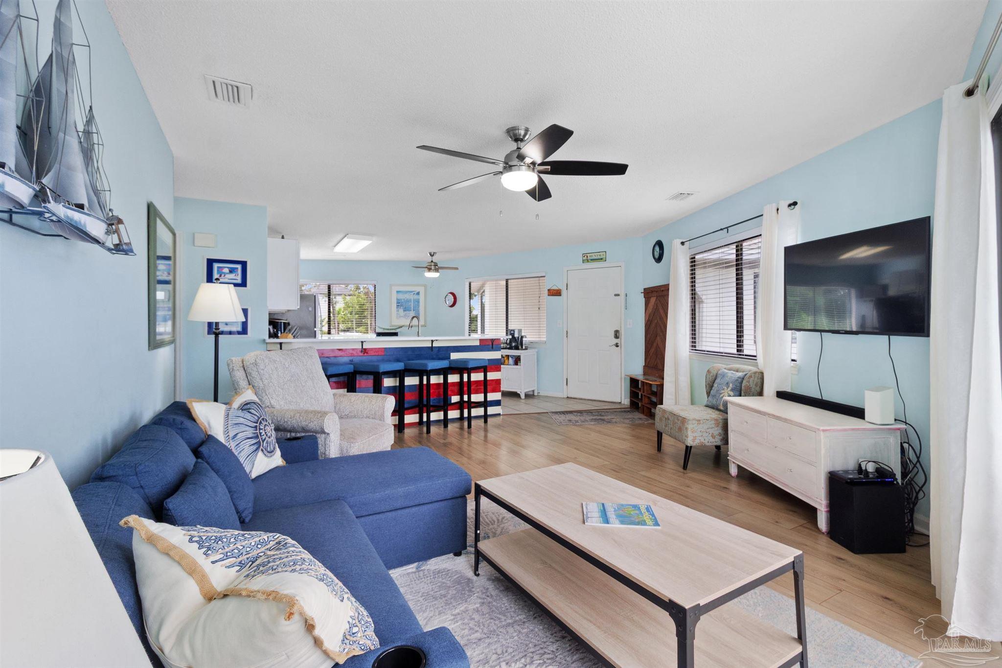 285 Payne Street, Unit 21B Miramar Beach, FL 32550 - Photo 10 of 42 a living room with furniture and a flat screen tv