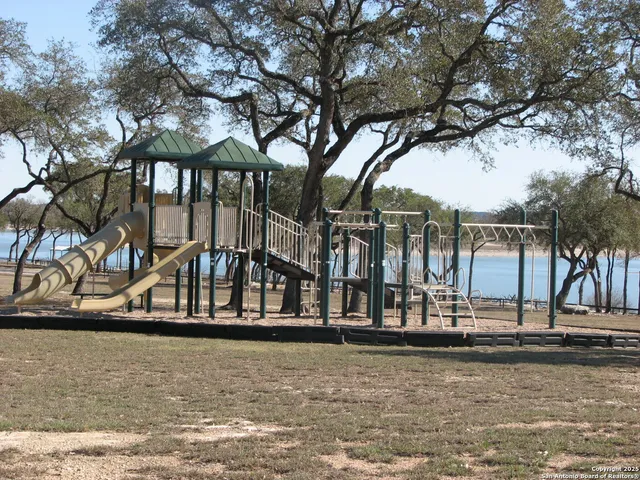 a view of swimming pool with yard and tree