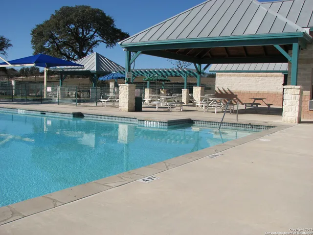 an outdoor space with swimming pool and furniture