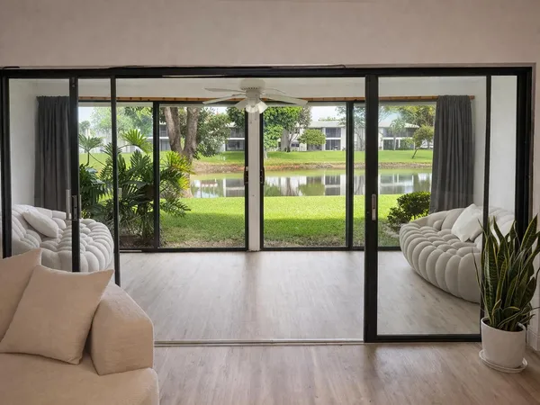 a living room with couch and a floor to ceiling window