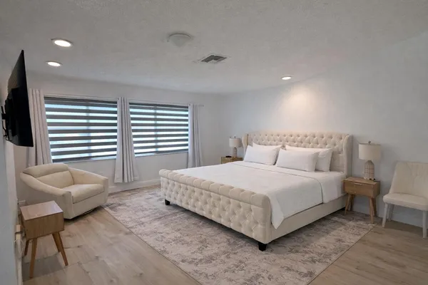 a bedroom with a bed and a couch