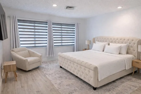 a bedroom with a bed and a couch