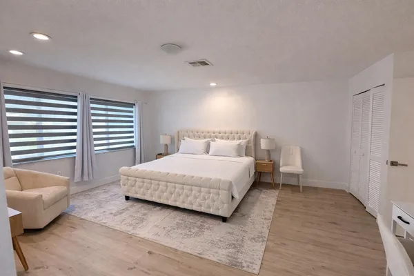 a bedroom with a bed and glass window