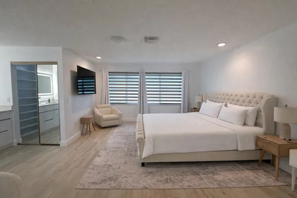a bedroom with a bed and a couch
