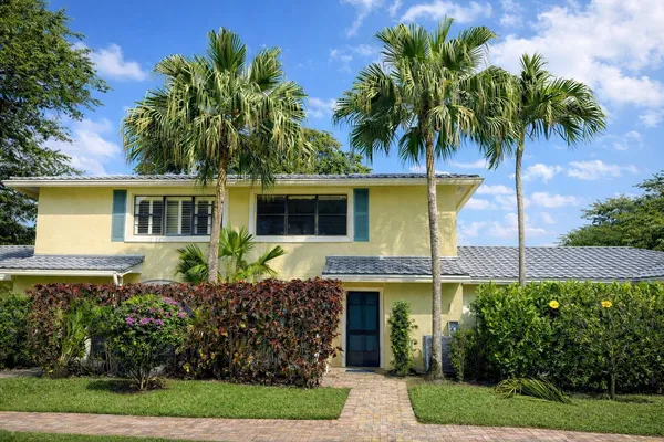 a front view of a house with a garden