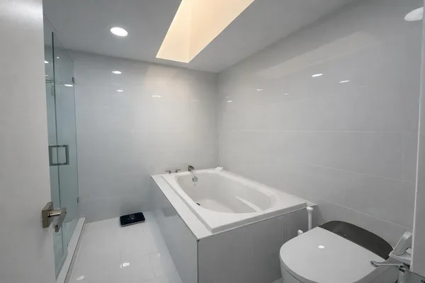 a bathroom with a toilet a sink a mirror and vanity