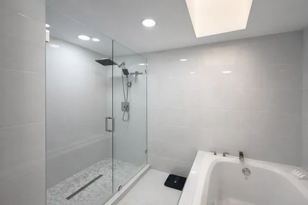 a bathroom with a bathtub and a shower