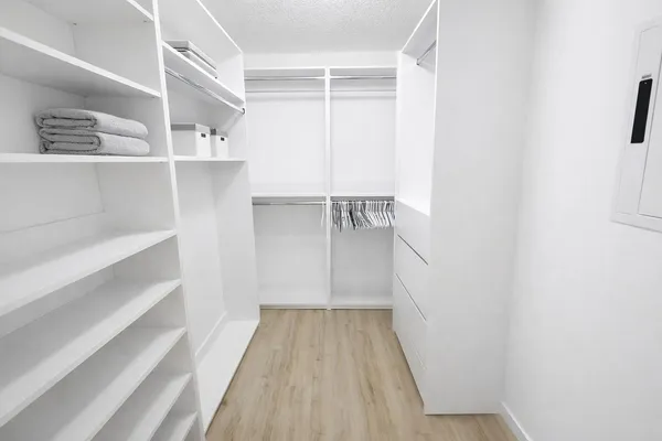 a view of walk in closet with empty racks