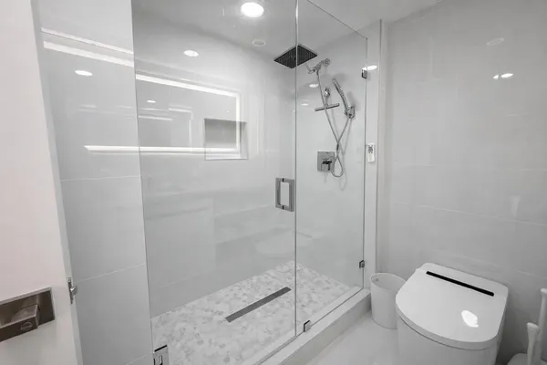 a bathroom with a shower a toilet and sink